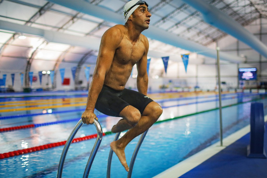 Syrian refugee swimmer Ibrahim Al Hussein stretches during a practice session for media in a training pool during the Rio 2016 Paralympic Games at Olympic Park on September 17, 2016 in Rio de Janeiro, Brazil.