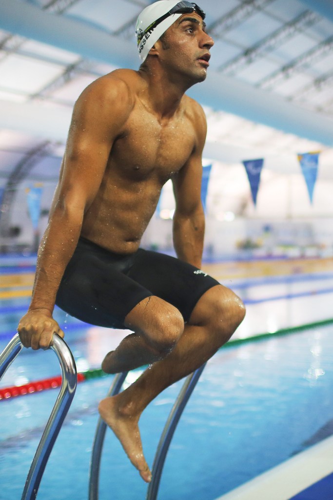 Syrian refugee swimmer Ibrahim Al Hussein stretches during a practice session for media in a training pool during the Rio 2016 Paralympic Games