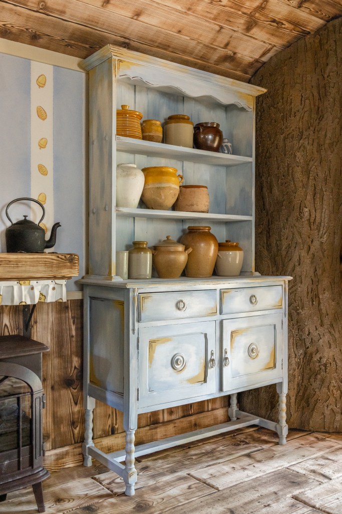 The specially commissioned kitchen dresser laden with honey pots.