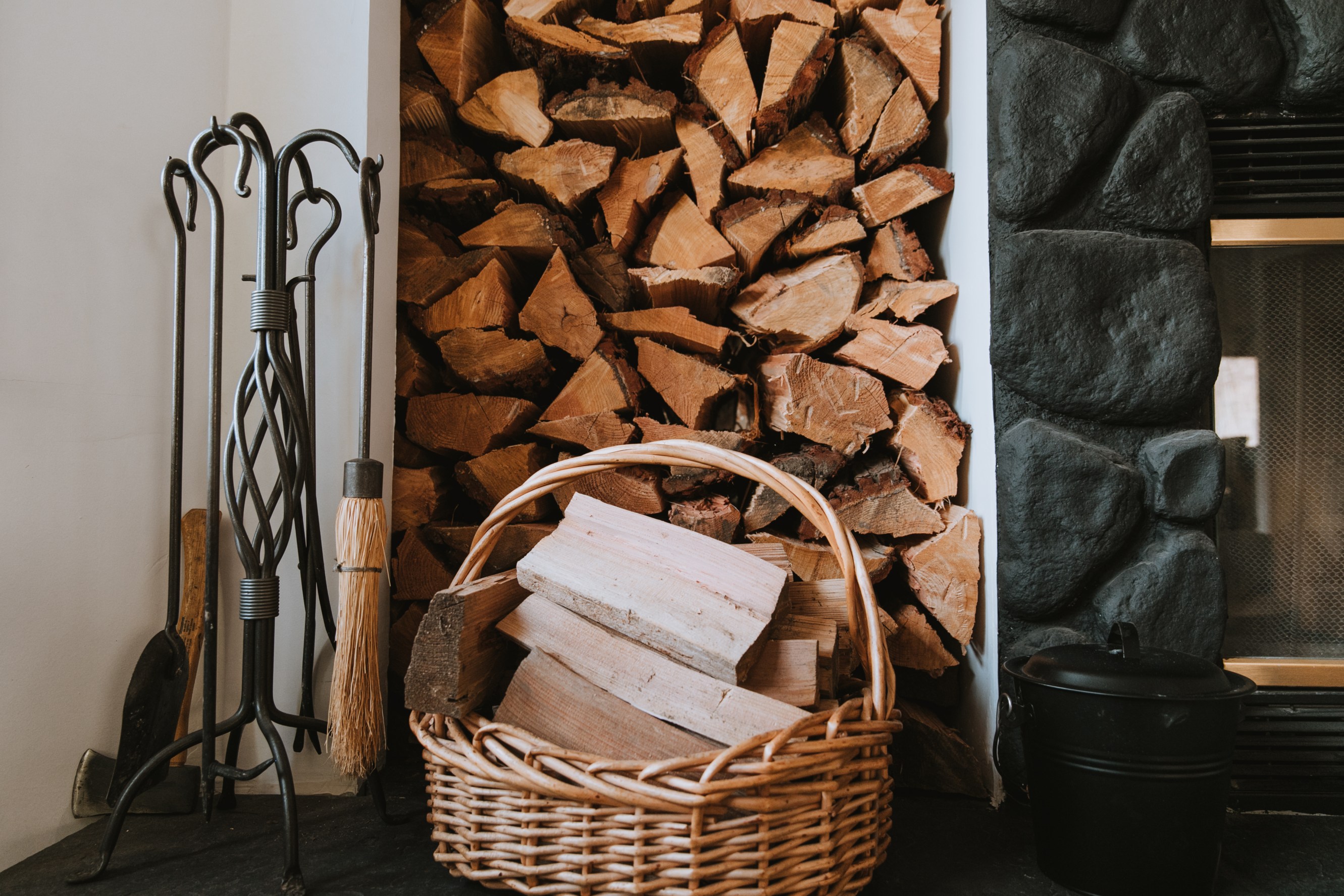 Freshly chopped wood in a basket and piled high next to the fireplace in Michelle's new listing.