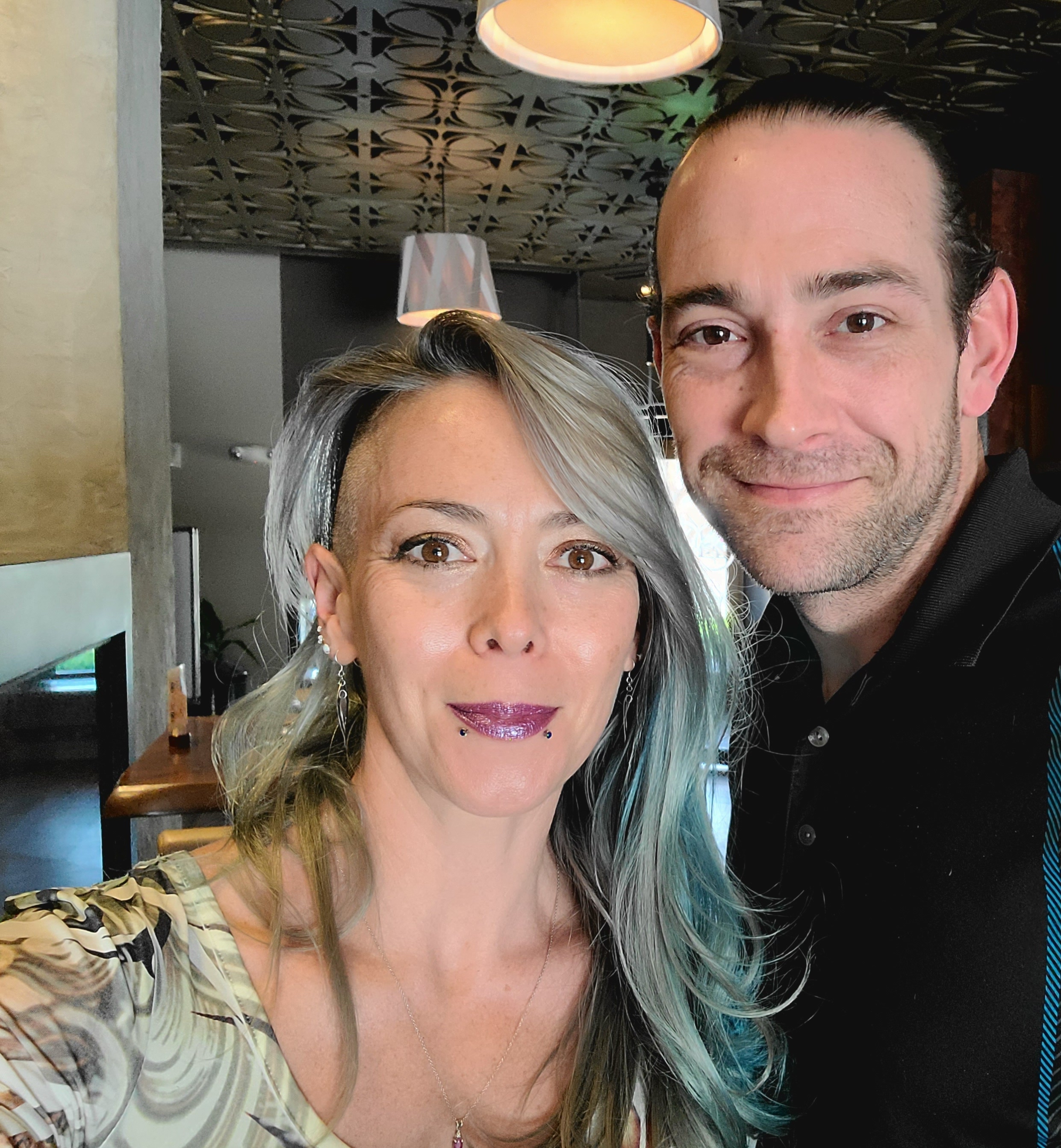 Man and woman posing for a selfie and smiling. 