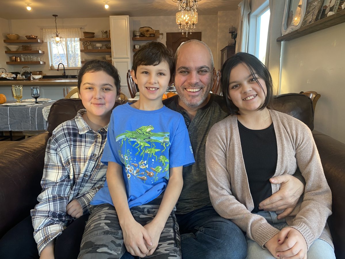 Ben, the most hospitable Host in Alaska seated with his three children.