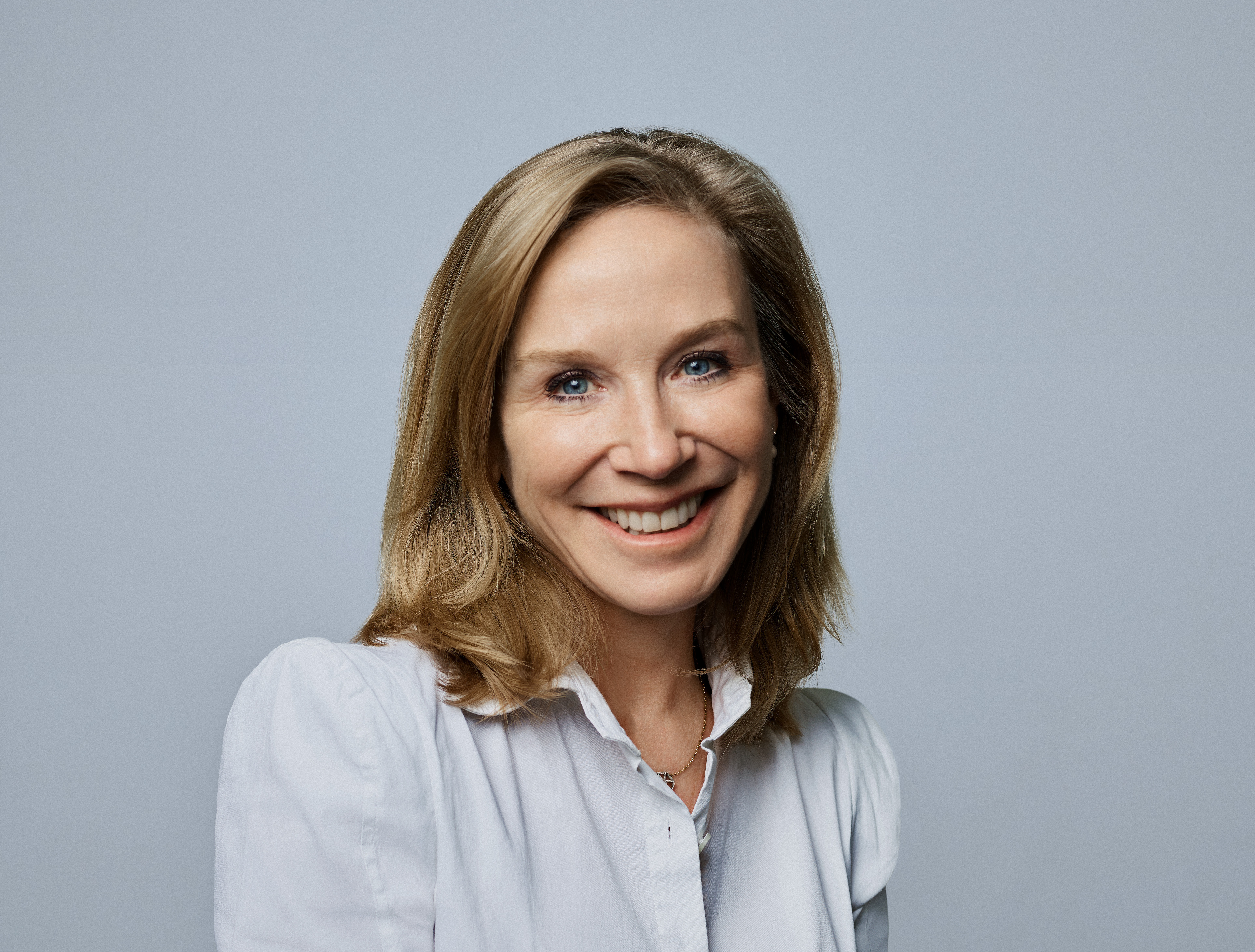 Catherine Powell smiling wearing business attire