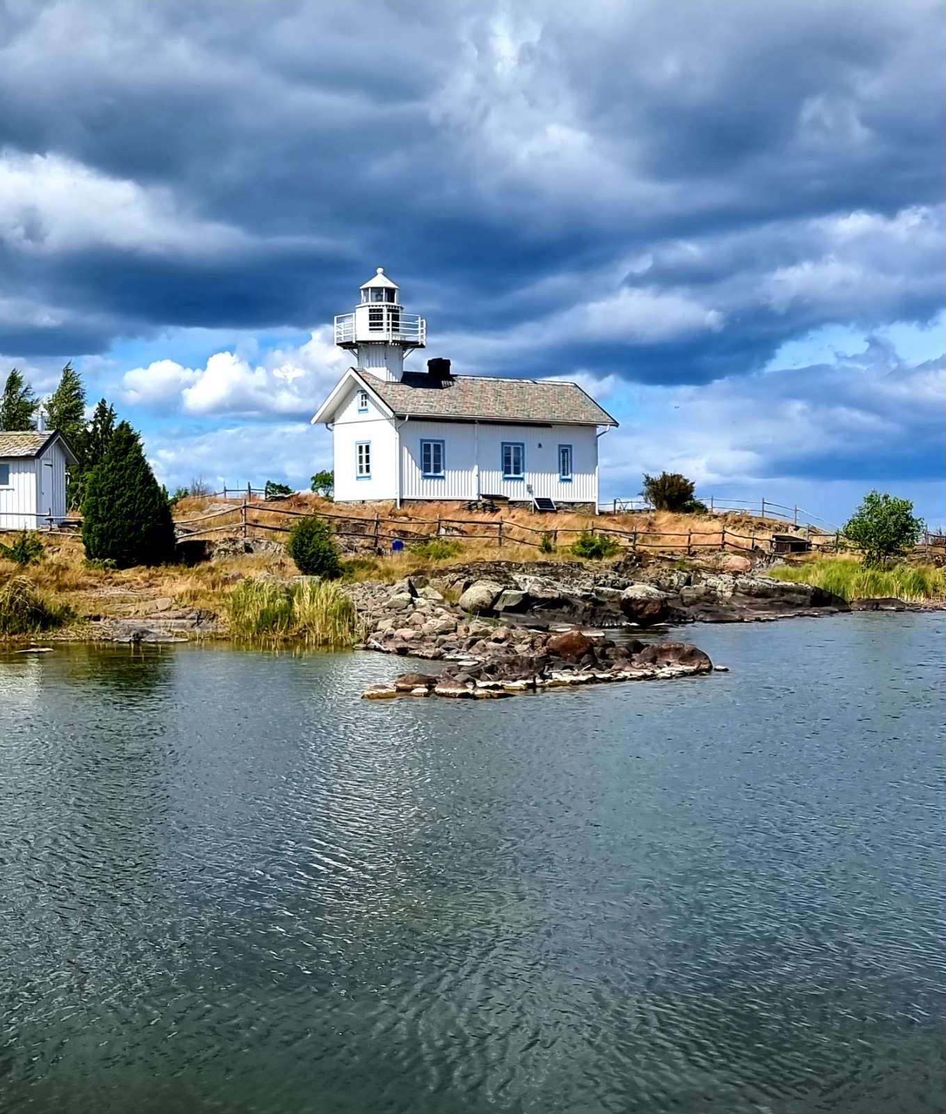 A Swedish lighthouse on a bay during the day.