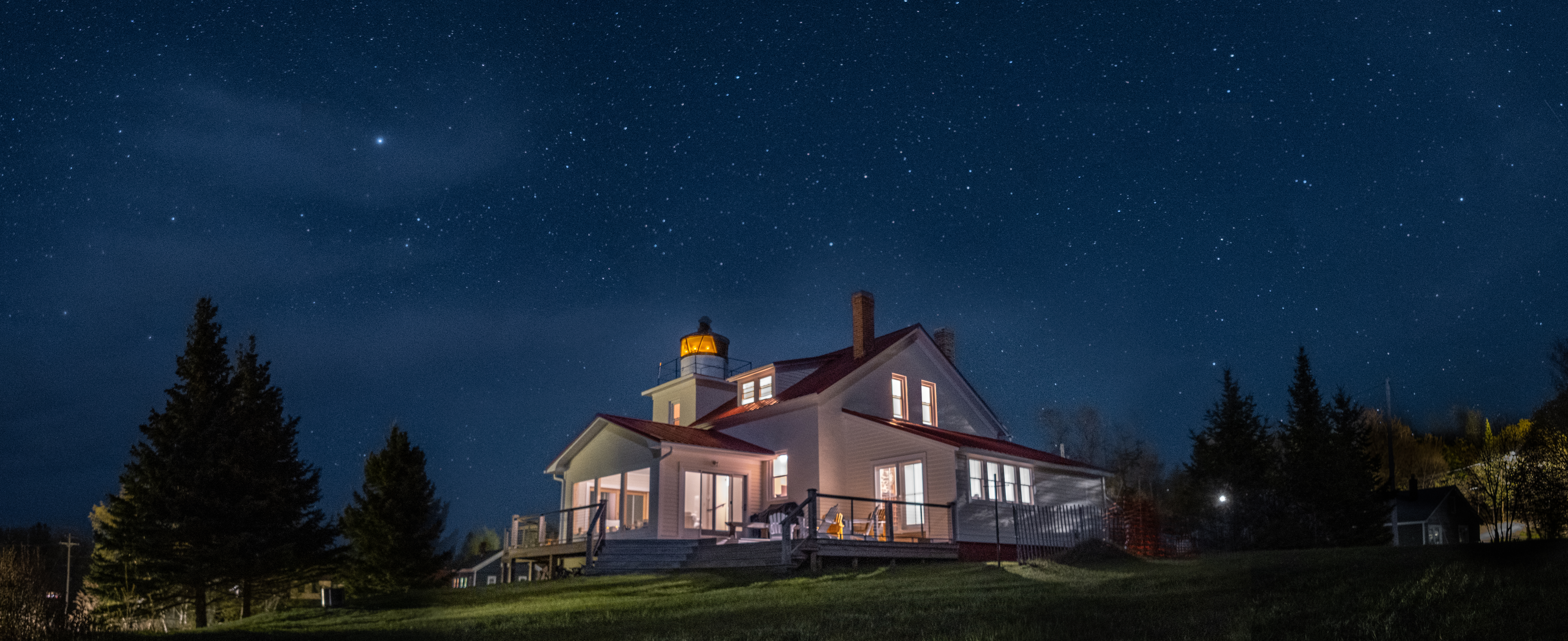 A lighthouse on Eagle River at night.