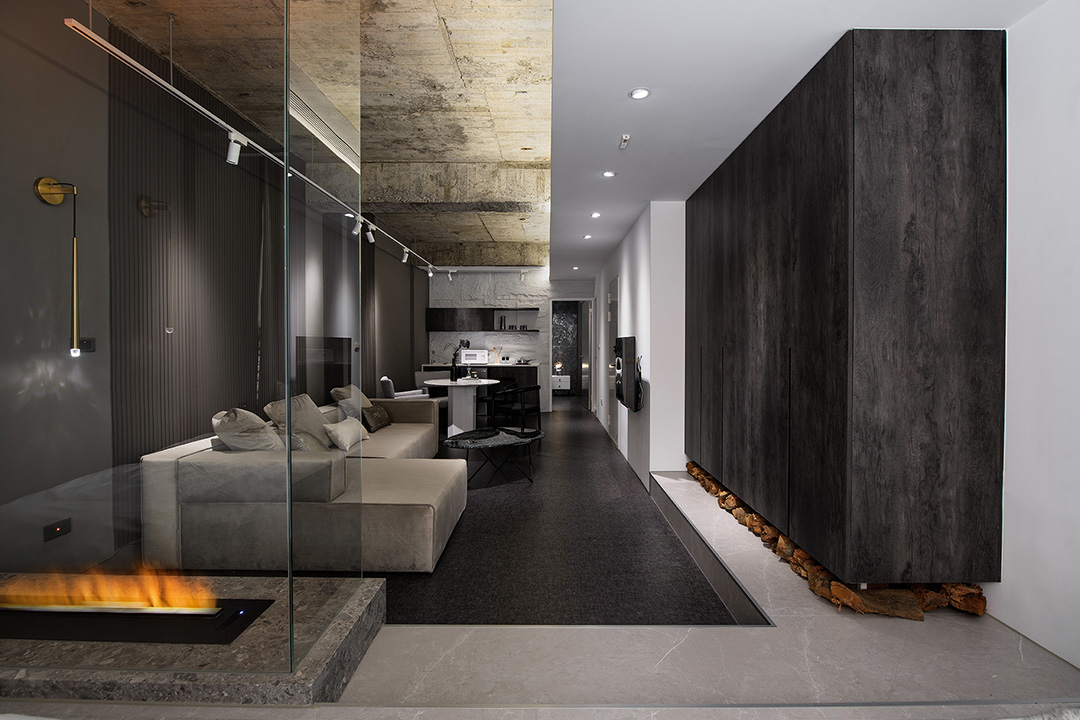 A dark, moody living room with a fireplace