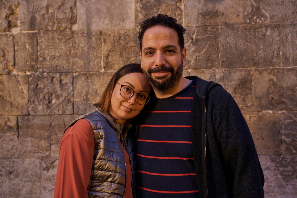 Smiling woman lays head on smiling man's shoulder