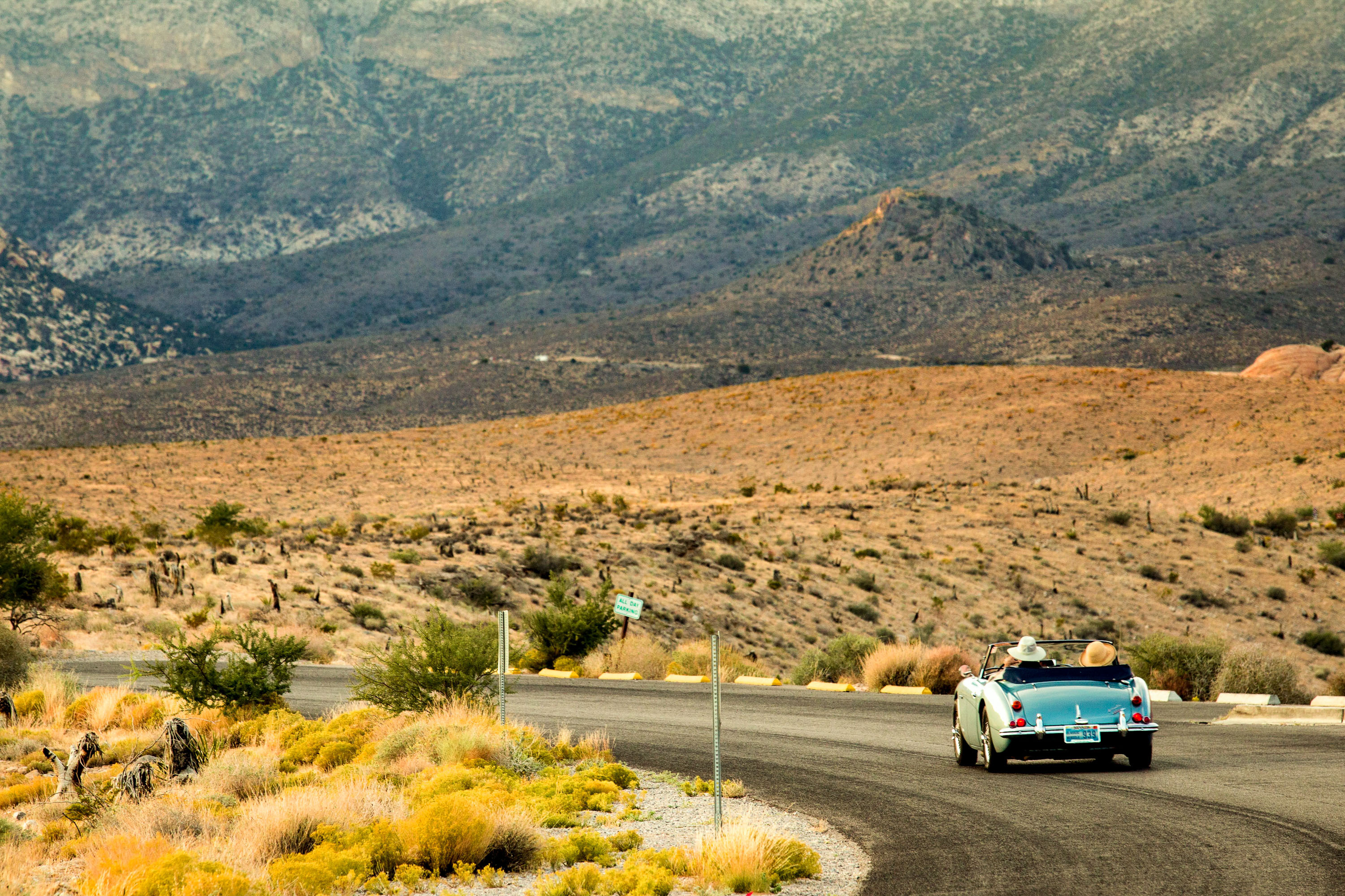 Convertible driving down desert highway