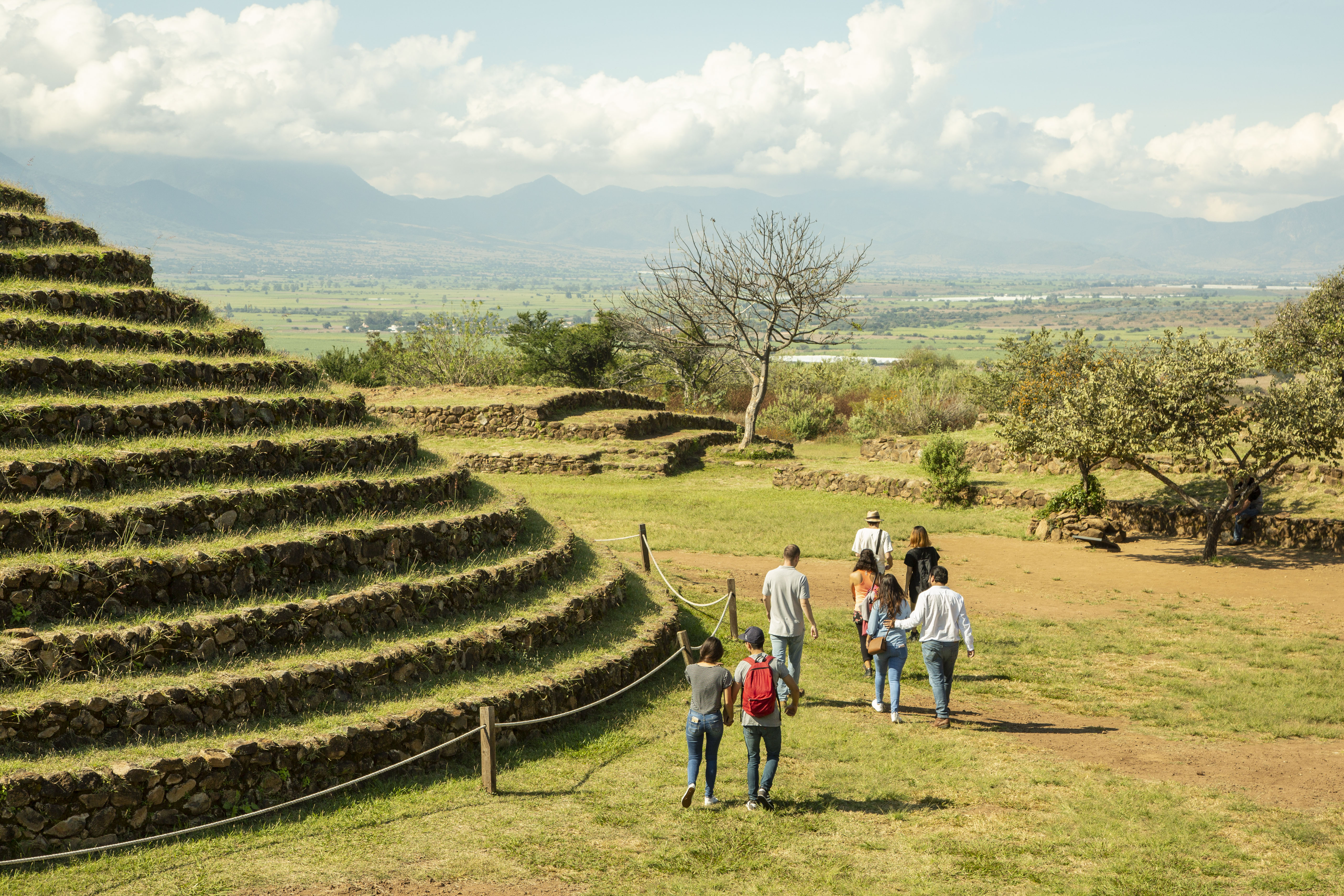 Group of people walking in a green open field in Guadalajara, Mexico