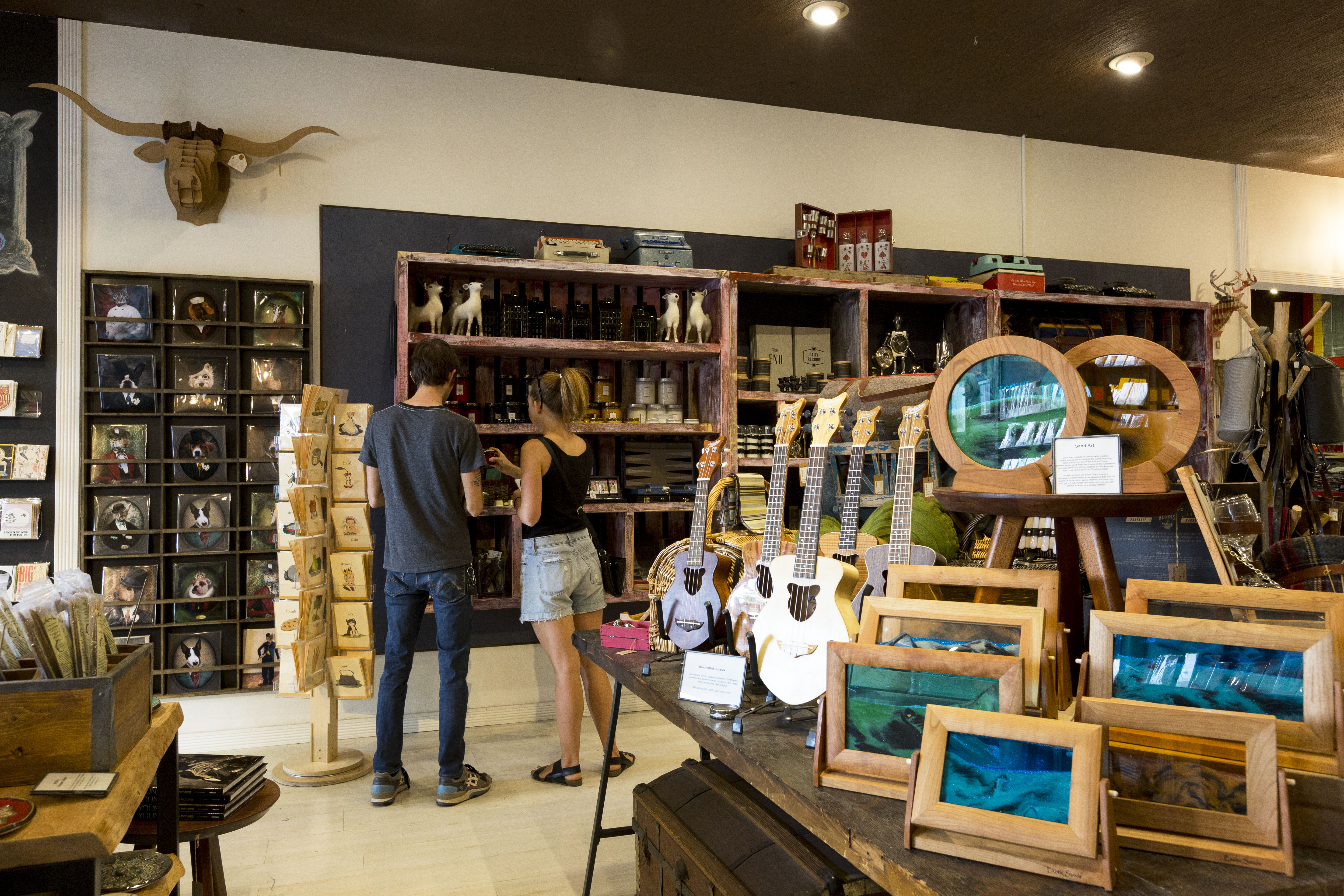 Two customers browse items at a local shop.