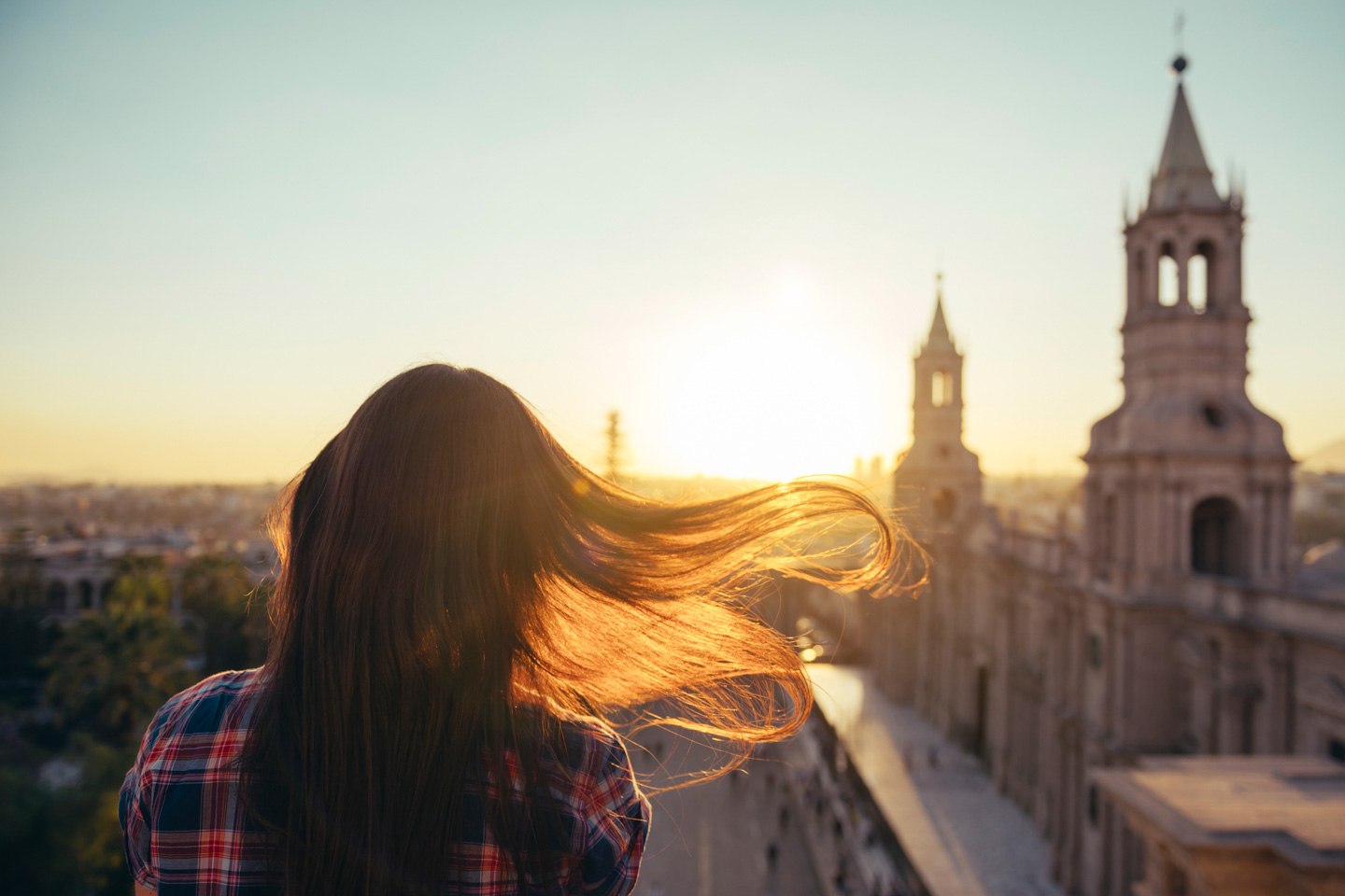 Peru, Arequipa, woman looking at Plaza de Armas enjoying sunset