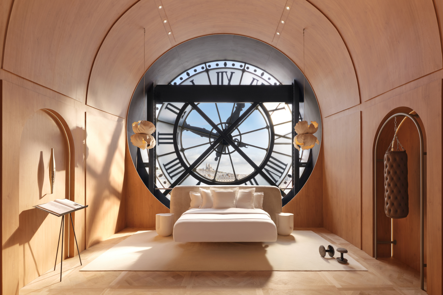 White bed against a large clock face window, in a wood paneled monochromatic bedroom.