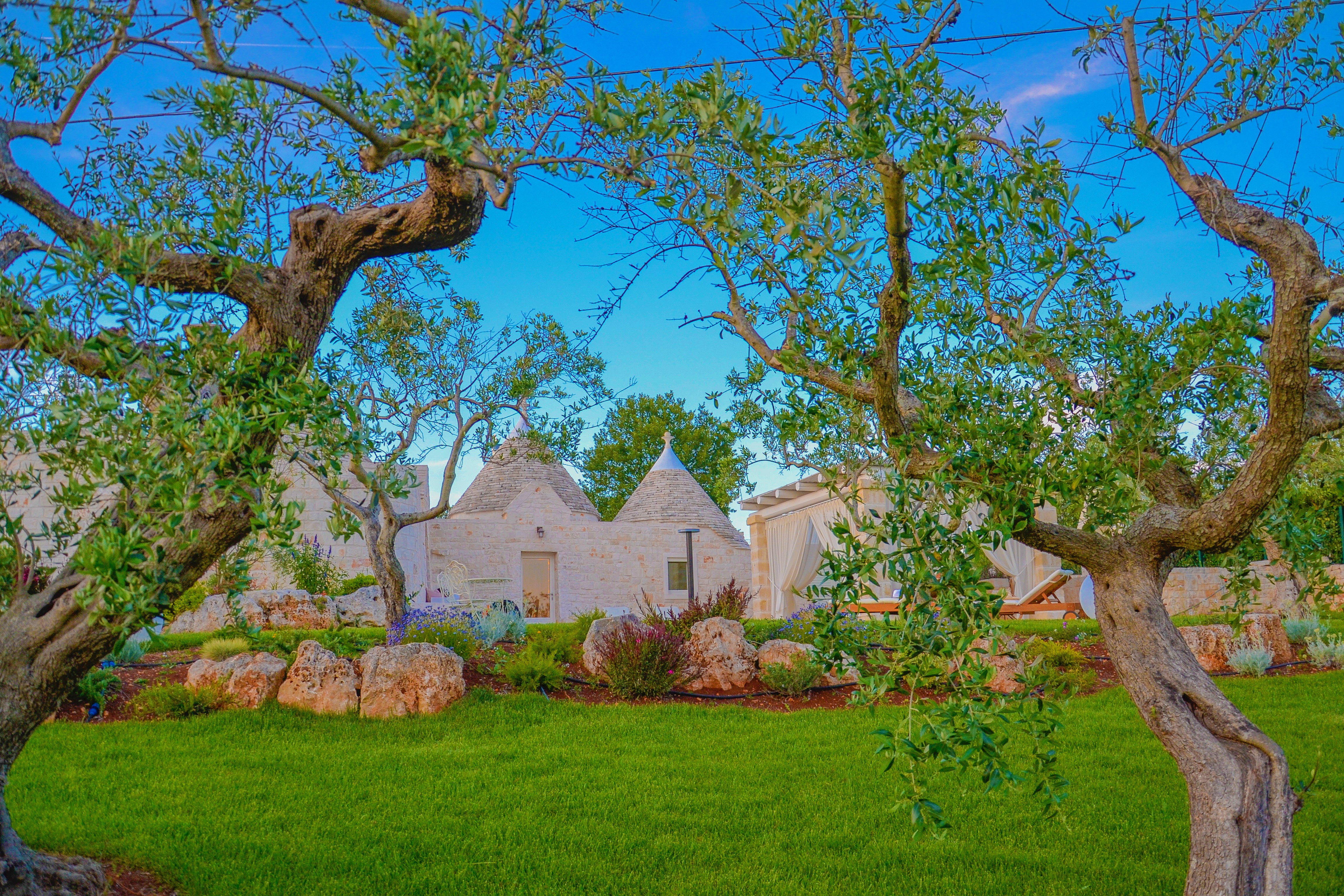 Exterior shot of an historic 'trullo' building in southern Italy - a classic stone-built home with a conical roof.
