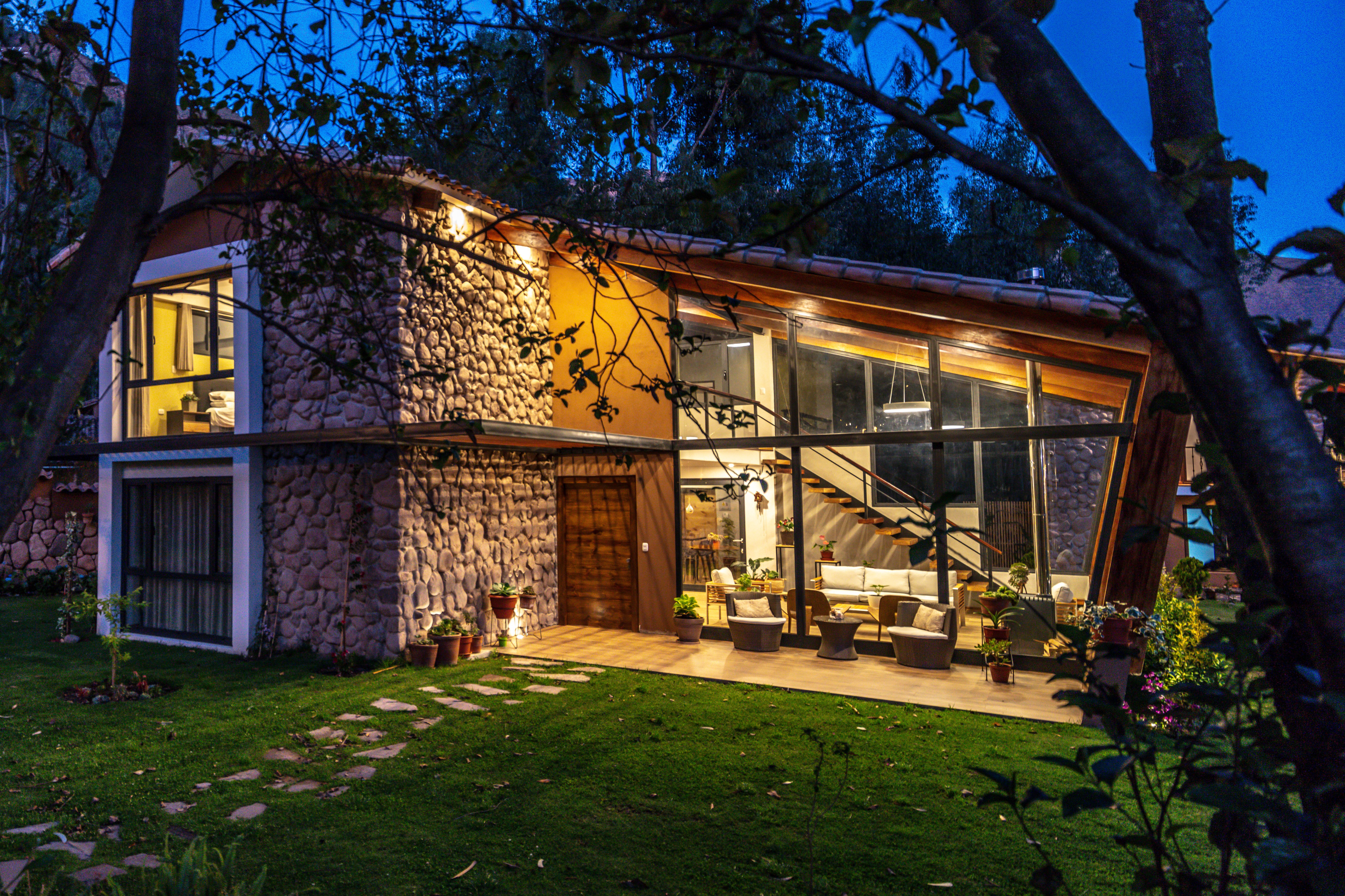 View of a home in the mountains of Perú during the night with the warm lights on inside