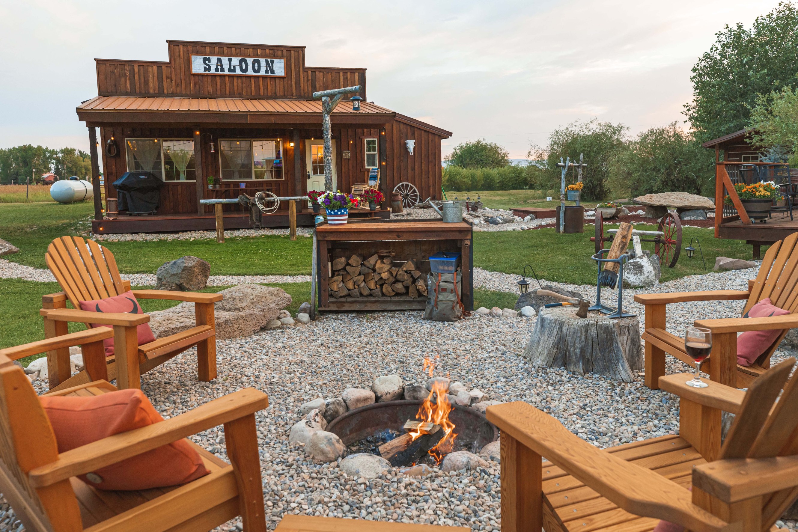 Saloon-style Airbnb with a fire pit and garden chairs in the foreground
