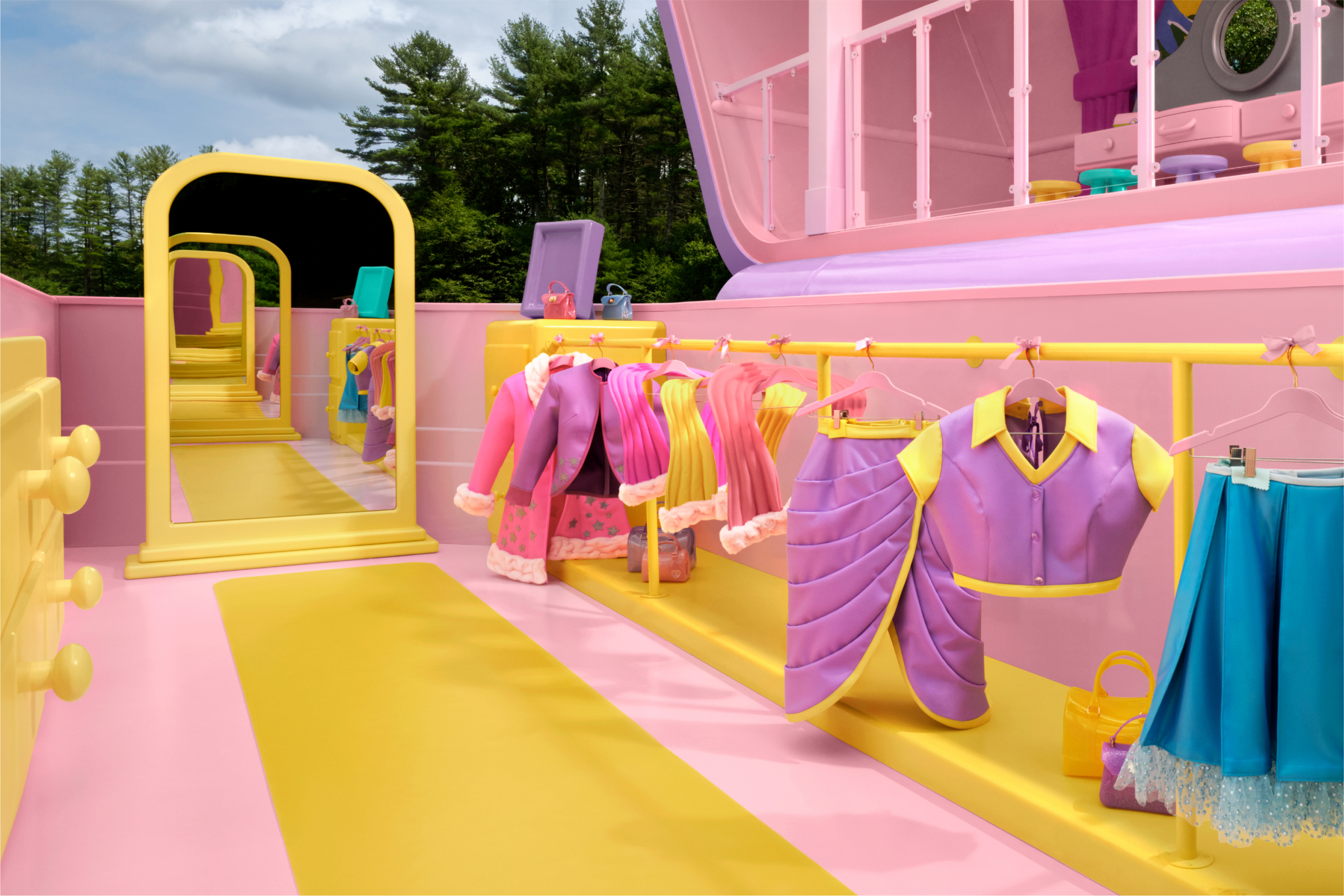 The closet area of the Polly Pocket compact with colorful clothes hanging on a bar, a full-length mirror, and a dresser.