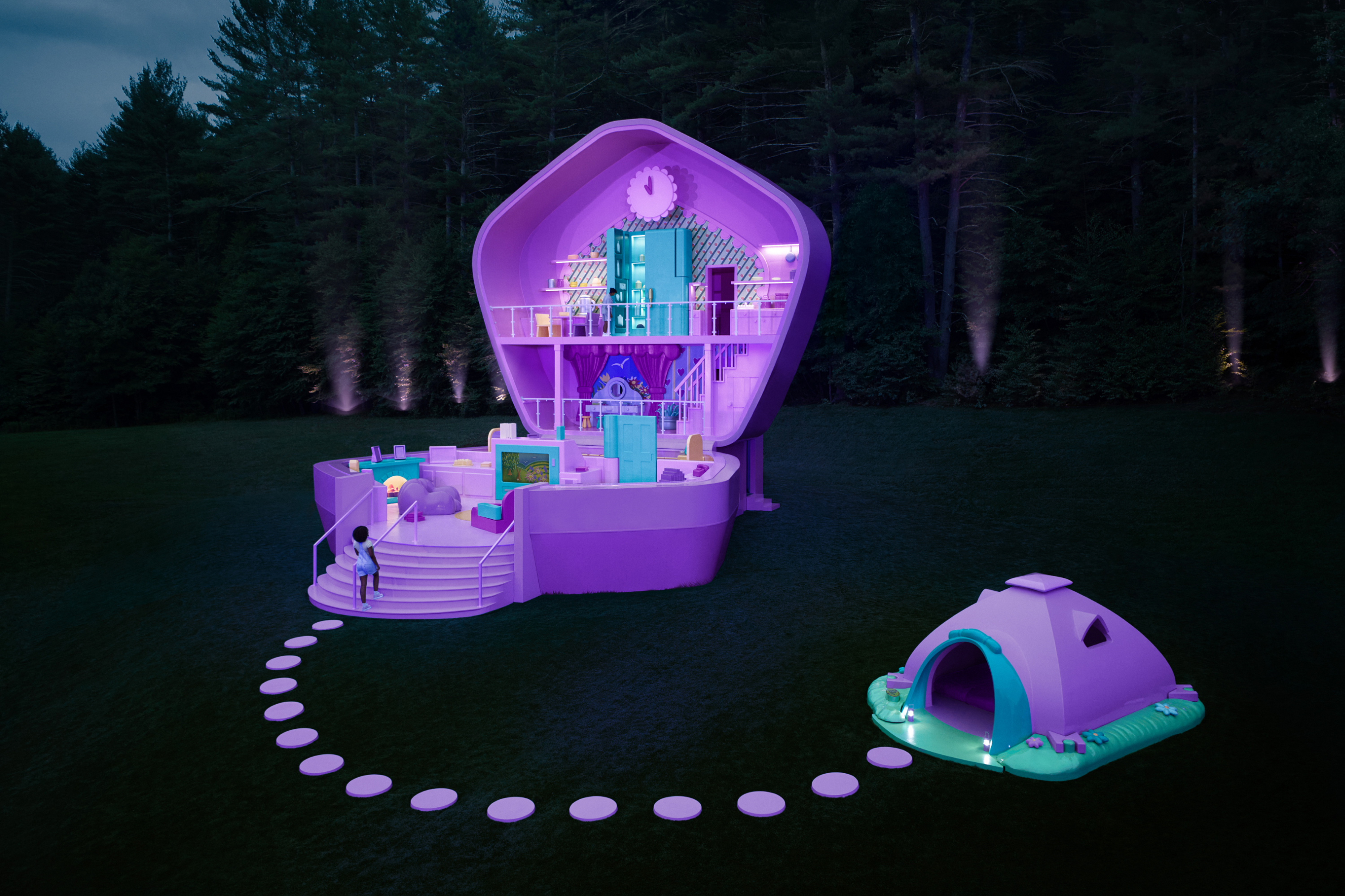 Nighttime view of Polly Pocket compact lit up, with purple up lights at the edge of the forest beyond. 