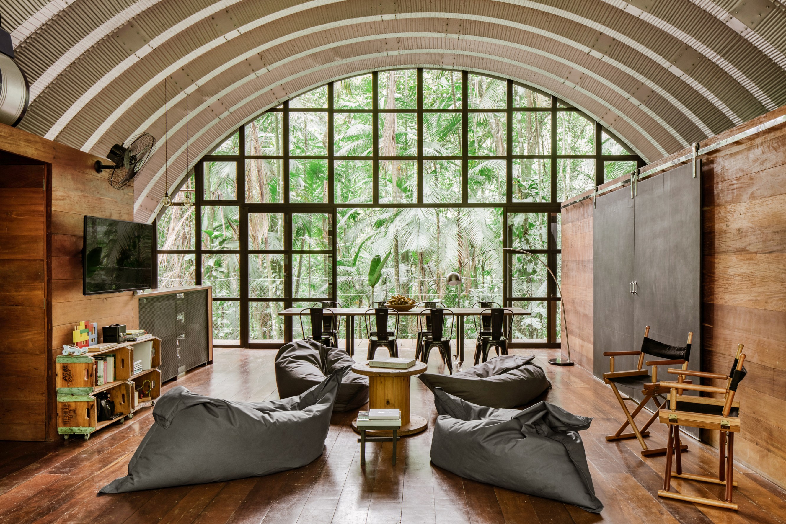Floor to ceiling windows that show the forest