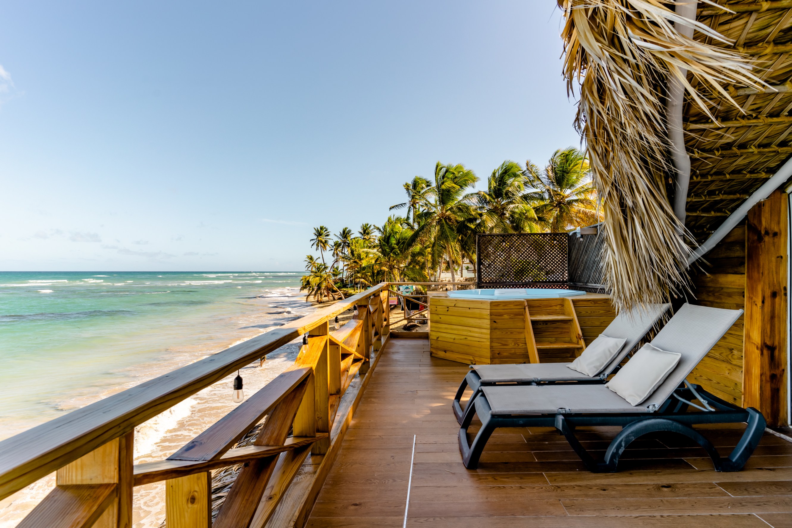 Backyard deck with a hot tub by the ocean
