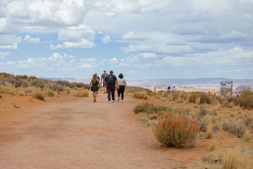 Group of people walking through the desert