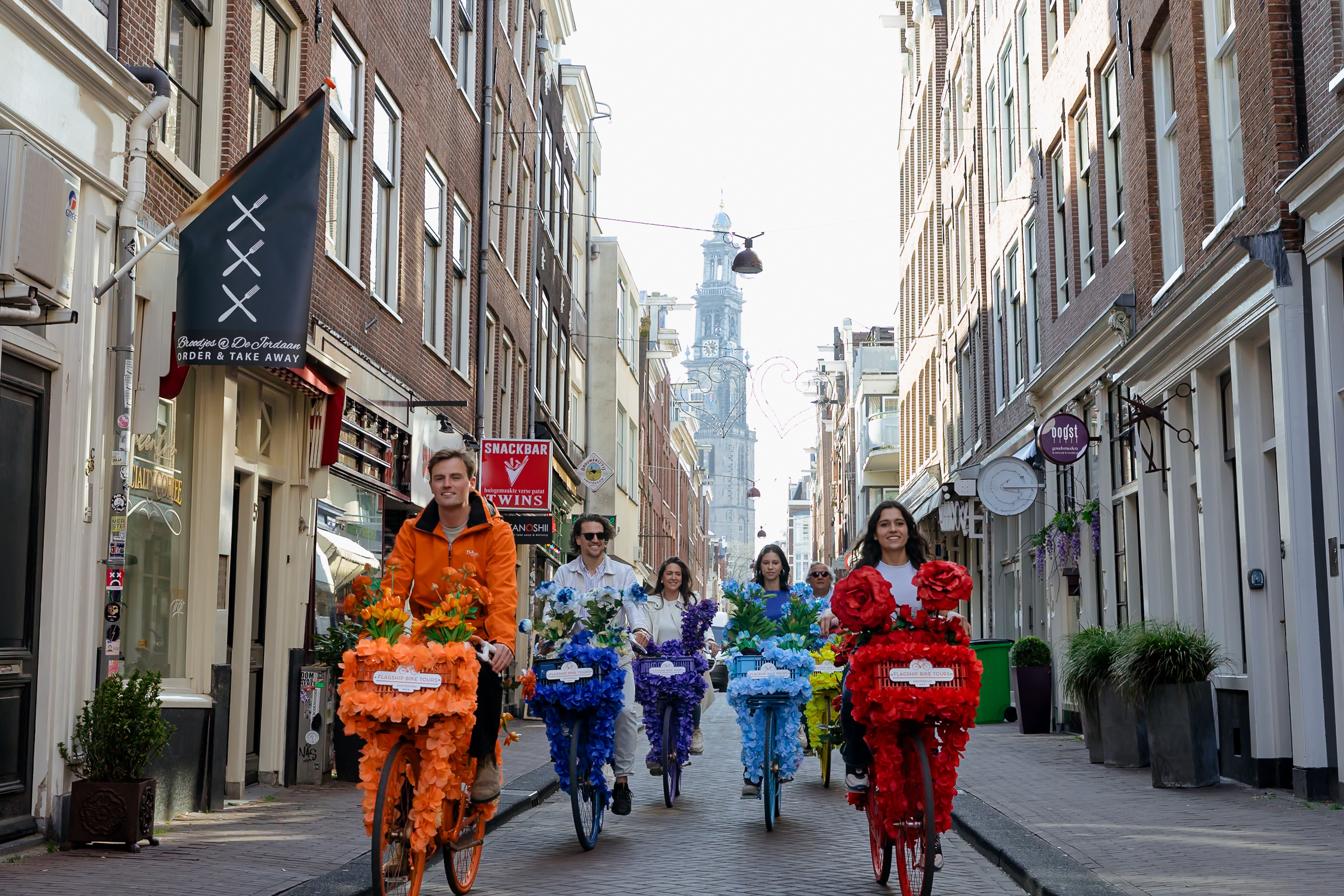 A group of people riding floral bikes in Amsterdam