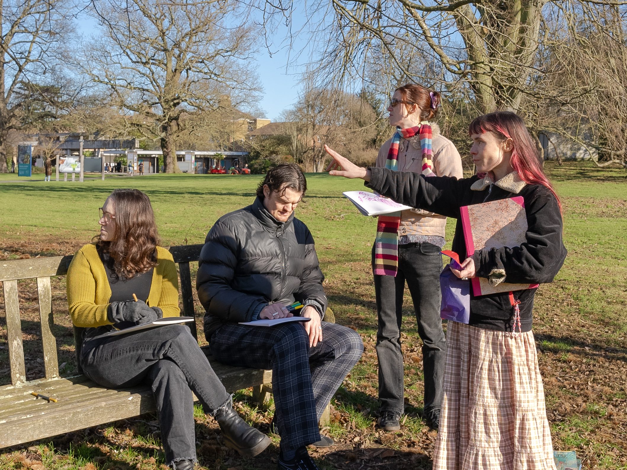 A group of people sitting on a bench in a garden