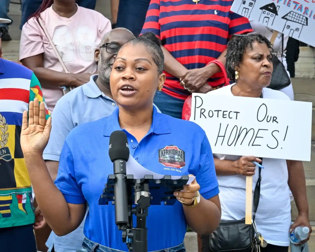 Woman speaks in front of rally crowd.