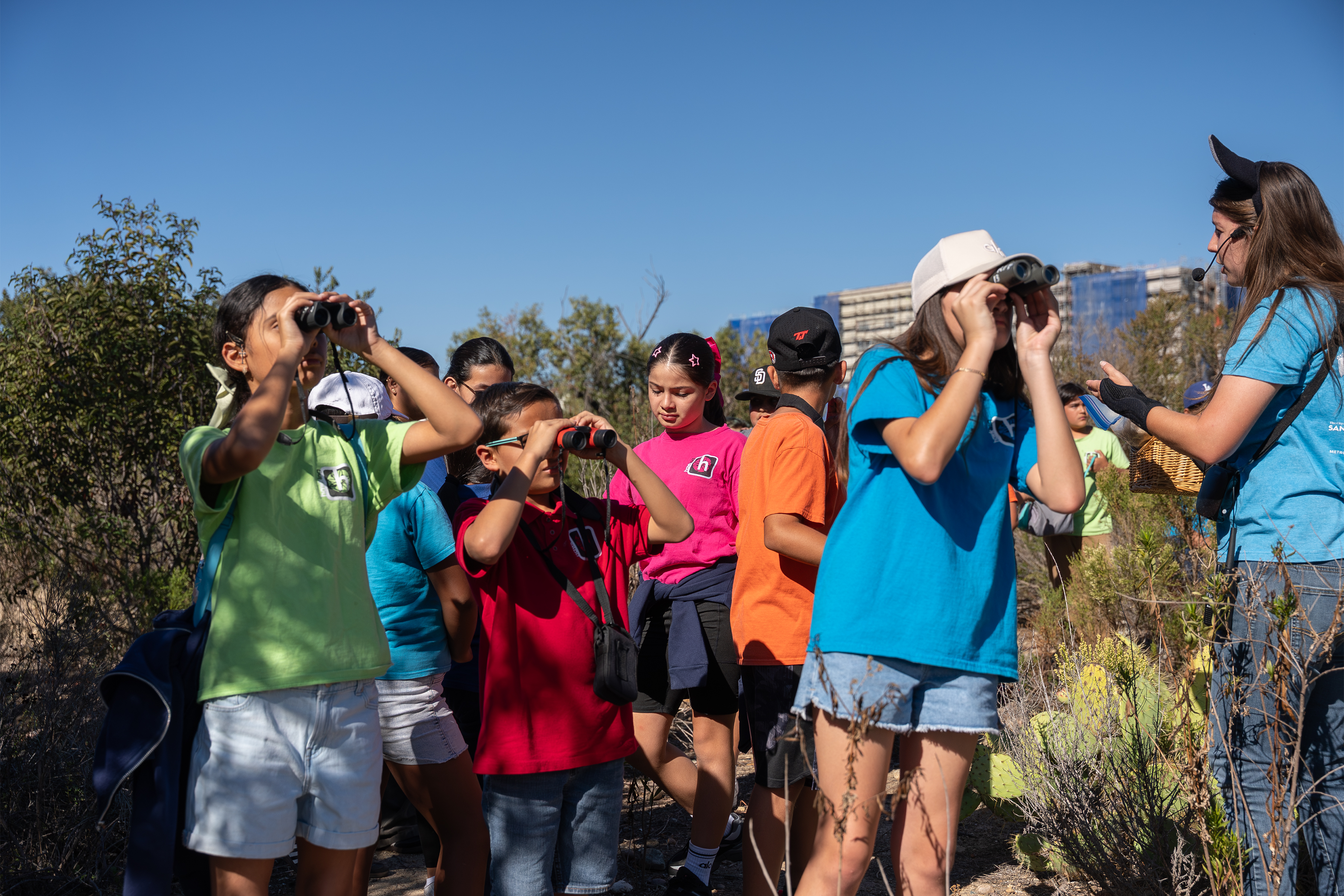 Children in a park using binoculars